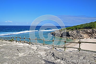 A beach nearby the famous Trou dArgent at Rodrigues Island taken from top with visible safety wooden barrier Stock Photo