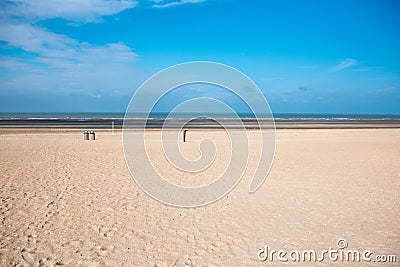 Beach of the North Sea in Koksijde, Belgium under blue sky Stock Photo