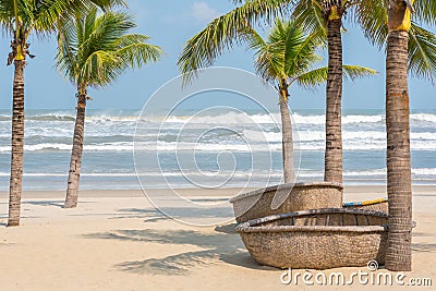 Beach with coconut trees and coracles in Danang, Vietnam Stock Photo