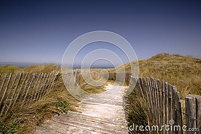 Beach with Path and Fence in Brittany Stock Photo