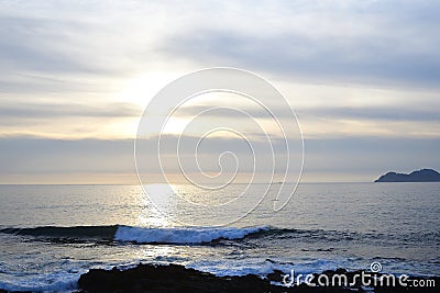 Sunset on the beach. Clouds on the horizon with a calm sea, Stock Photo