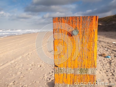 Beach post with sea level marker Stock Photo