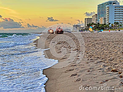 Beach Raker smoothing sand at dawn Stock Photo