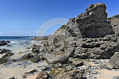 Beach with rock overhang Stock Photo