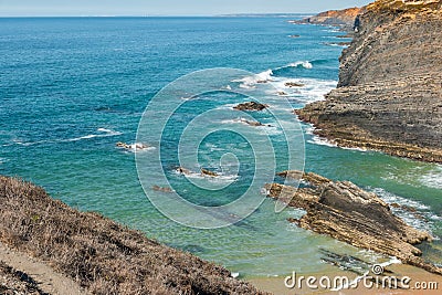 Beach with rocks in Praia do Cavaleiro in Alentejo, Portugal Stock Photo