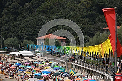 Beach with row of colorful flags and umbrellas Editorial Stock Photo