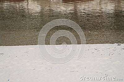 Beach sand and reflecting water Stock Photo