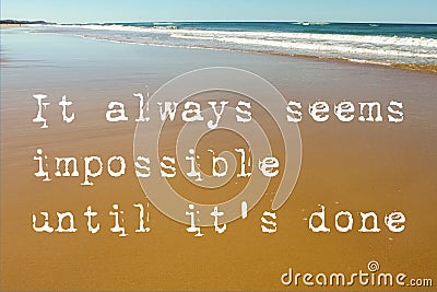Beach Scene of wet sand with waves in the background and the motivational quote it always seems impossible until it`s done Stock Photo