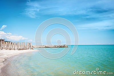 Beach of the sea coast with white sand and blue sky. Stock Photo