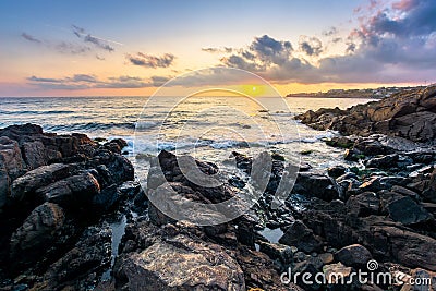 beach of the sea at sunset. wonderful scenery with stones in the water Stock Photo