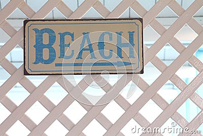 Beach sign on a white trellis Stock Photo