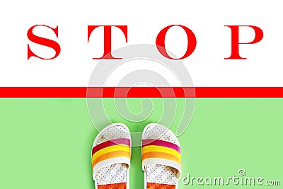 Beach Slippers slates in front of the red line and stop sign Stock Photo