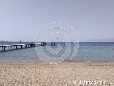 Beach with small wood pier Stock Photo