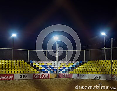 Beach soccer field through the fence mesh. Sand play concept. Competition sponsors. View of the viewer. Team Confrontation Editorial Stock Photo