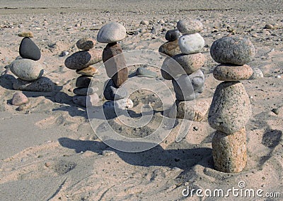 Beach stone figures marching off into the distance Stock Photo