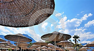 Beach straw umbrellas on the Mediterranean sea coast, Kemer, Turkey Editorial Stock Photo