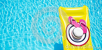 Beach summer holiday background. Inflatable air mattress, flip flops and hat on swimming pool. Yellow lilo and summertime Stock Photo