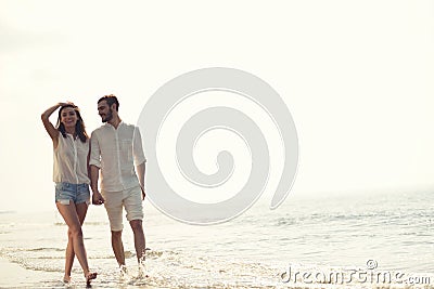 Happy fun beach vacations couple walking together laughing having fun on travel destination. Stock Photo