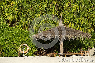 Beach Umbrella made of palm leafs on the background of an exotic Stock Photo