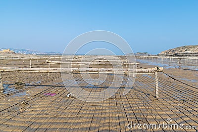 The beach under the blue sky, the laver and oyster farms are on the beach Stock Photo