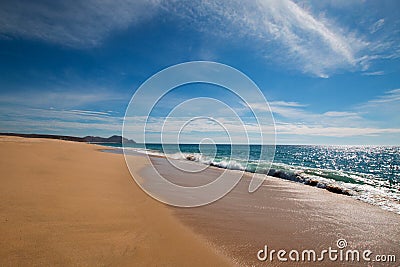 Beach under cirrus cloudscape at the Todos Santos artist community in central Baja California Mexico Stock Photo