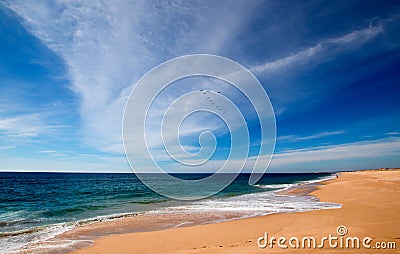 Beach under cirrus cloudscape at the Todos Santos artist community in central Baja California Mexico Stock Photo