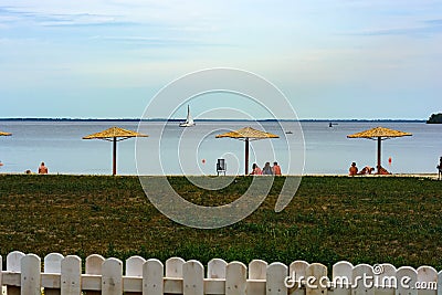 Beach vacation. Straw umbrellas on the coast. Editorial Stock Photo