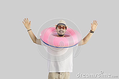 Funny traveler or tourist man wearing inflatable ring studio headshot portrait Stock Photo