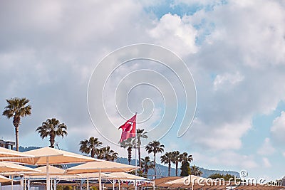 Beach view on turkish beach on turkey flag, umbrellas, bright sunny weather. travel Turkey background concept. Copy Stock Photo