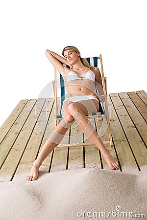 Beach - Woman in bikini sunbathing on deck chair Stock Photo