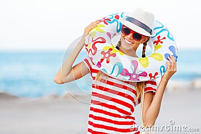 Beach woman happy and colorful wearing sunglasses and beach hat having summer fun during travel holidays vacation Stock Photo