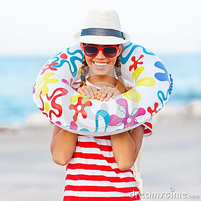 Beach woman happy and colorful wearing sunglasses and beach hat having summer fun during travel holidays vacation Stock Photo