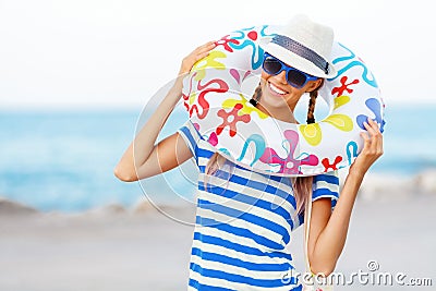 Beach woman happy and colorful wearing sunglasses and beach hat having summer fun during travel holidays vacation Stock Photo