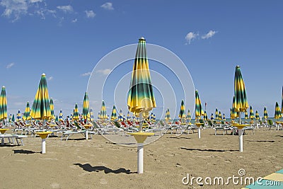 Beach summer parasols umbrellas with beach chairs Stock Photo