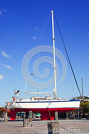 Beached sailboat for the yearly hull paint Stock Photo