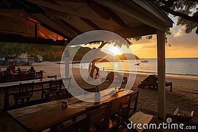 beachside eatery with view of sunset, offering barbecue and other grilled fare Stock Photo