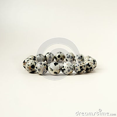 Bead stringing hand bracelet decoration. Hand made gem stone dalmatian jasper fashion accessory. Stock Photo