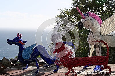 Beaded african artwork or curios placed on a rock wall at Chapmans Peak, Cape Town Editorial Stock Photo