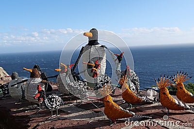 Beaded african artwork or curios placed on a rock wall at Chapmans Peak, Cape Town Editorial Stock Photo