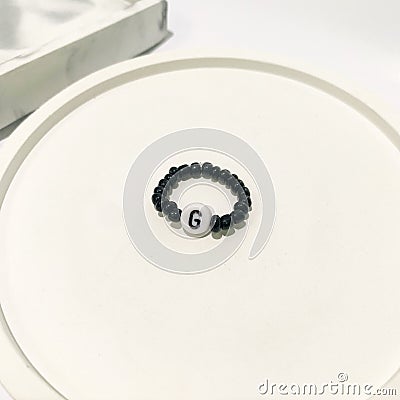 Beaded initial ring. Isolated in white background Stock Photo