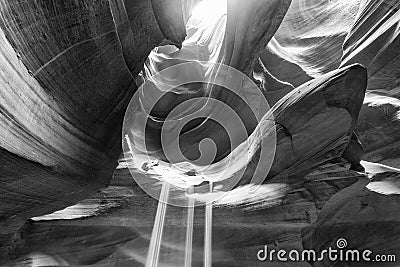 Beam of sand is flowing off the rocks in the interior of the narrow walls of the winding Antelope Canyon, Arizona Stock Photo