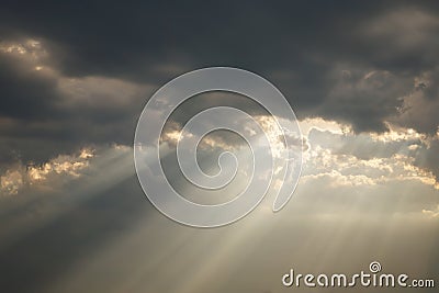 A beam of sunlight breaks through a dense cloud Stock Photo