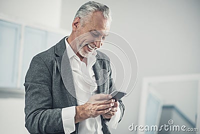 Beaming man feeling happy while reading good wishes Stock Photo