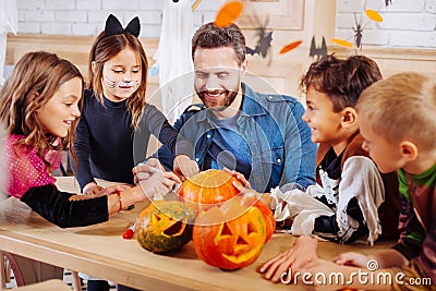 Beaming man inviting his children and nephews for Halloween party Stock Photo