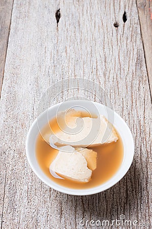 Bean junket eaten hot with gingered syrup, Soy custard Stock Photo