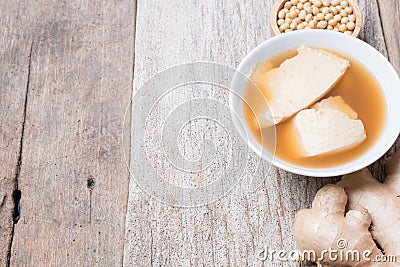 Bean junket eaten hot with gingered syrup, Soy custard Stock Photo