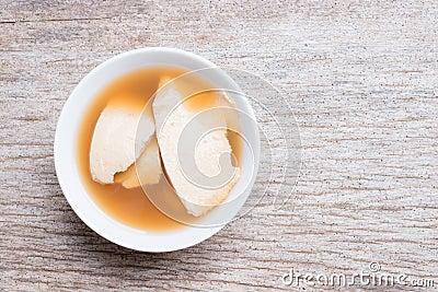 Bean junket eaten hot with gingered syrup, Soy custard Stock Photo