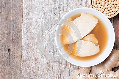 Bean junket eaten hot with gingered syrup, Soy custard Stock Photo