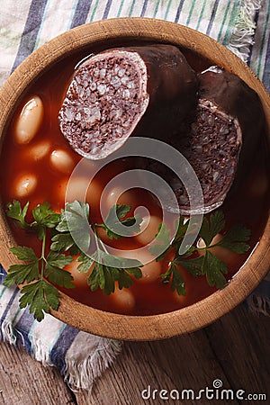 Bean soup with sausage morcilla closeup. vertical top view Stock Photo