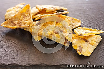 Beans chips on plack rustic plate. Healthy food without giving up pleasure Stock Photo